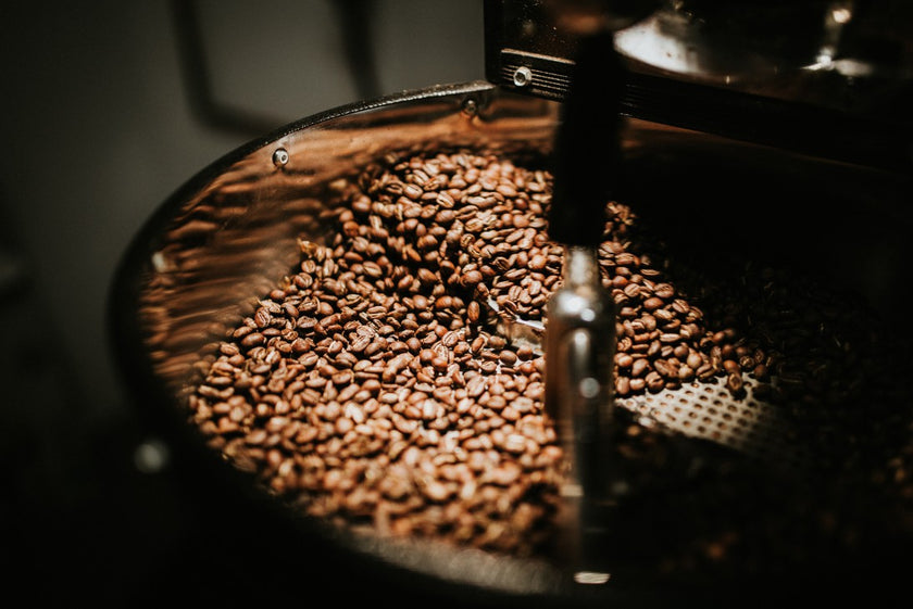 Coffee beans being ground in a coffee grinder
